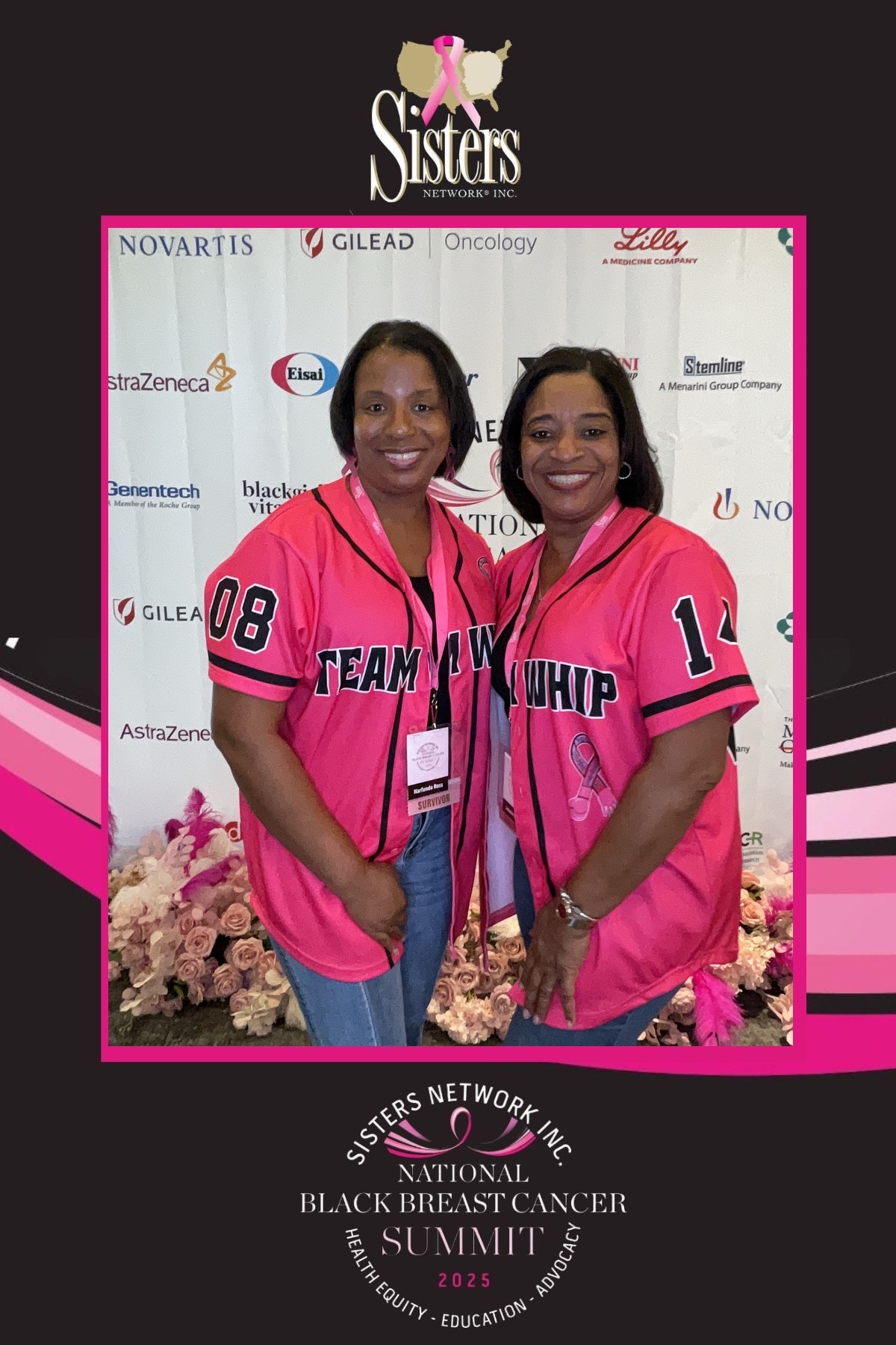 Two women in pink shirts with black text, standing in front of a backdrop with logos and pink flowers.