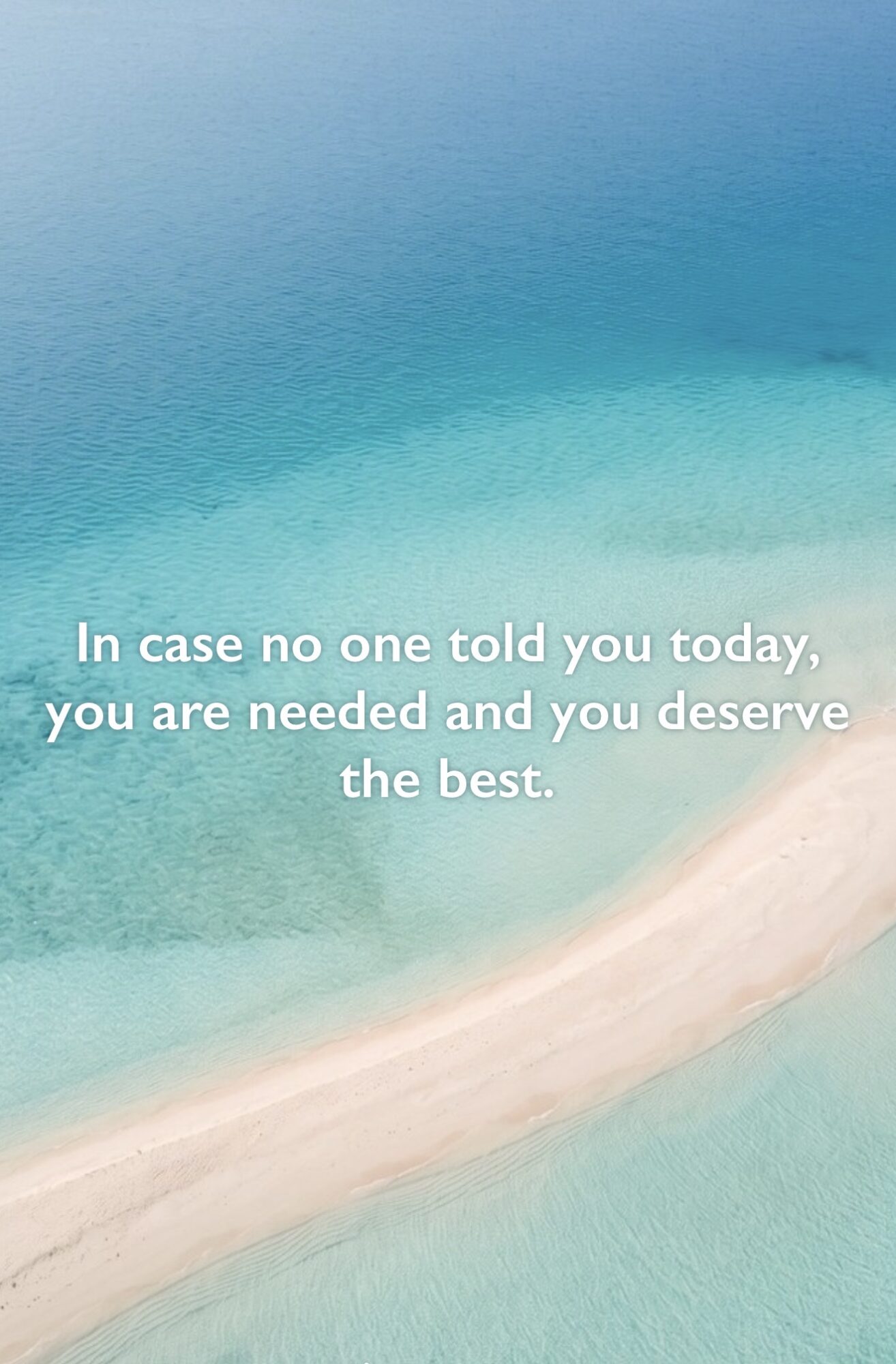 Aerial view of a beach with clear blue water and white sand, with an inspirational quote overlayed.