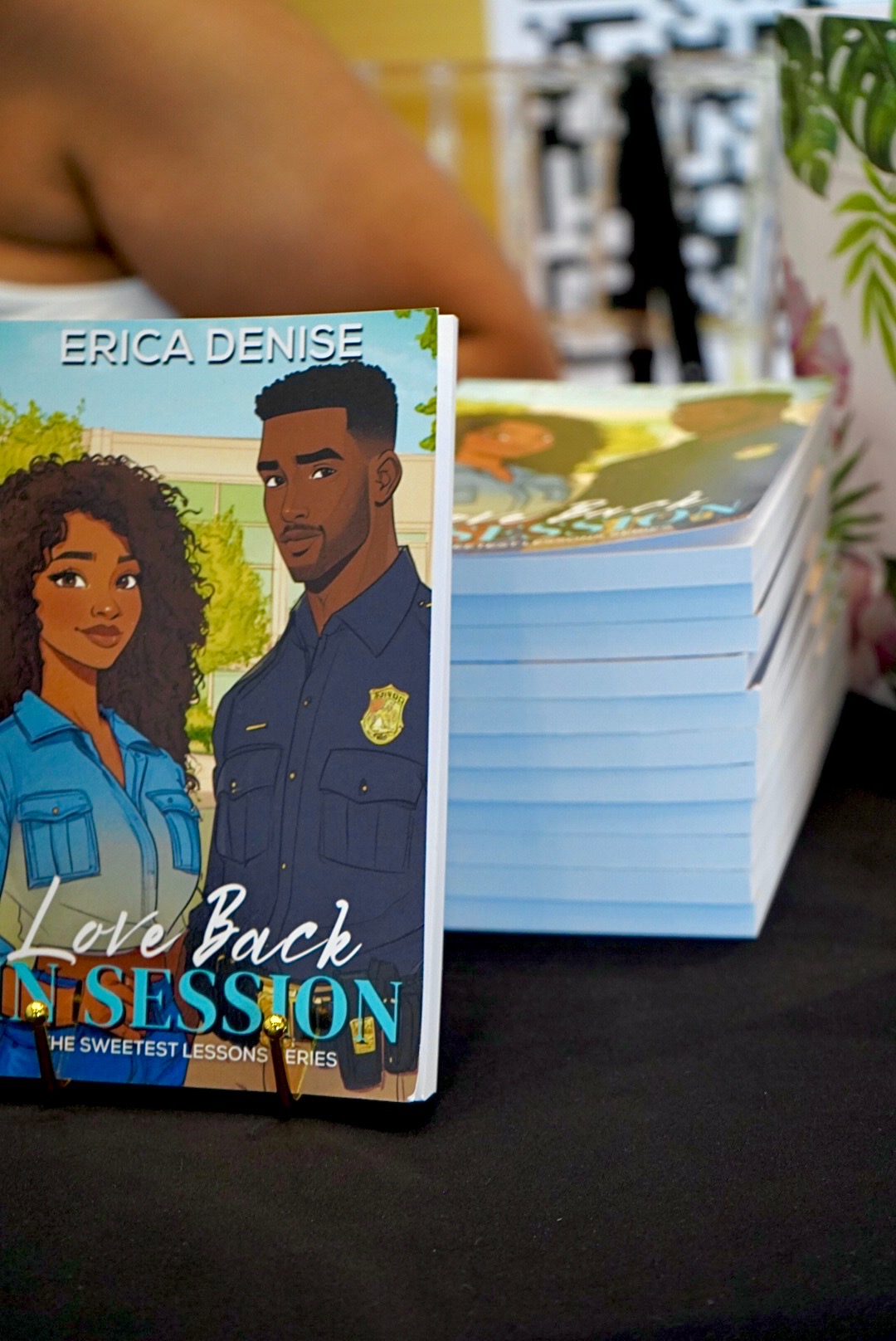 Stack of books with a colorful cover featuring two characters in police uniforms, one woman and one man, on top.