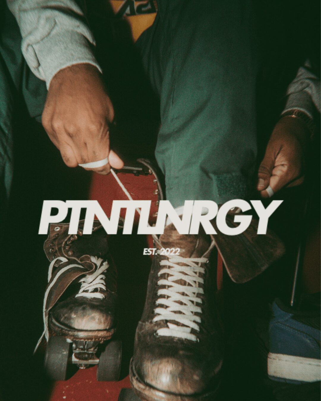 Person tying shoelaces on roller skates, with the word PINNURGY overlayed, and a dark background.