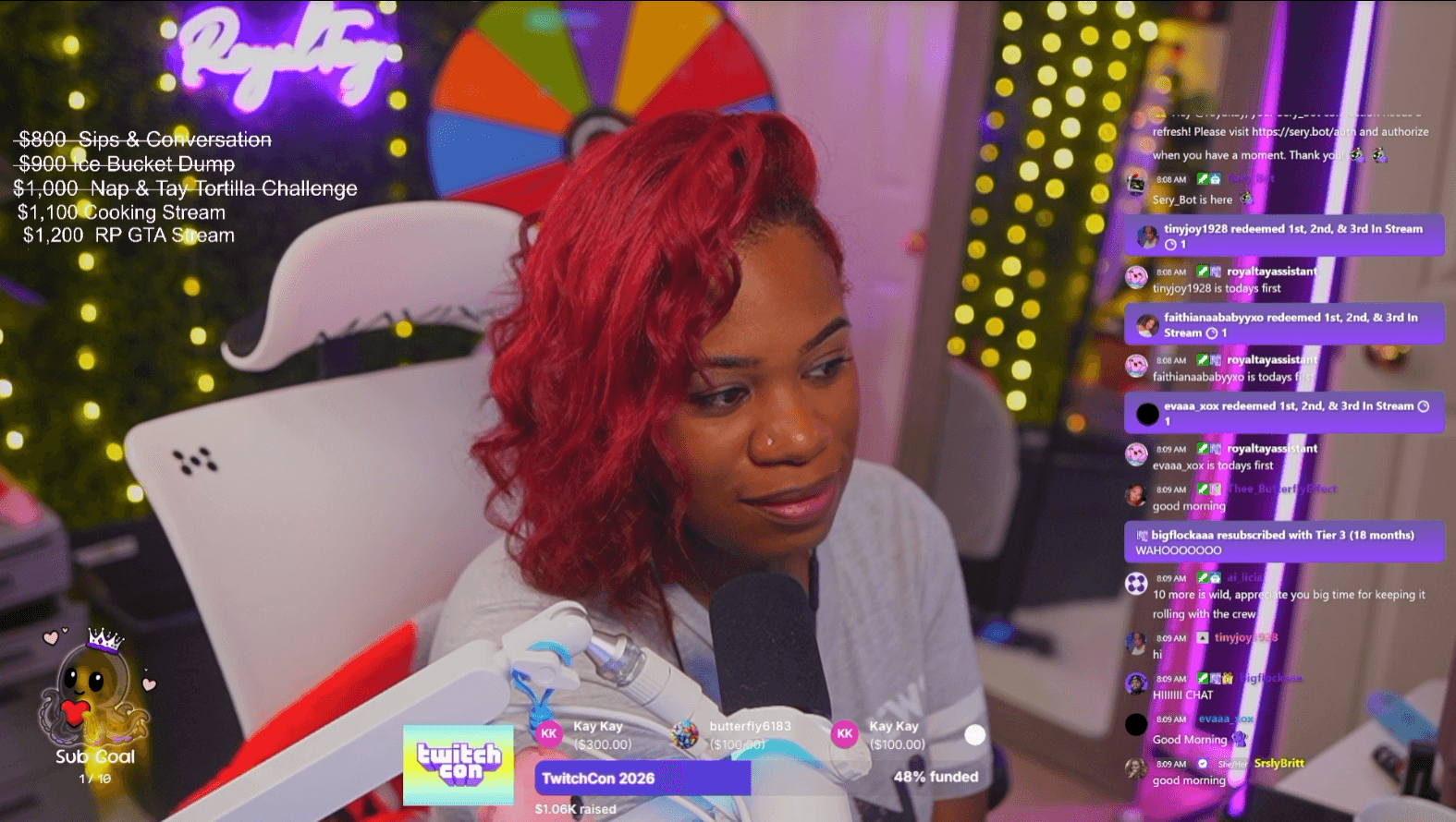 Woman with red hair sitting in a chair in a colorful, illuminated room, speaking into a microphone, with chat messages on the right.