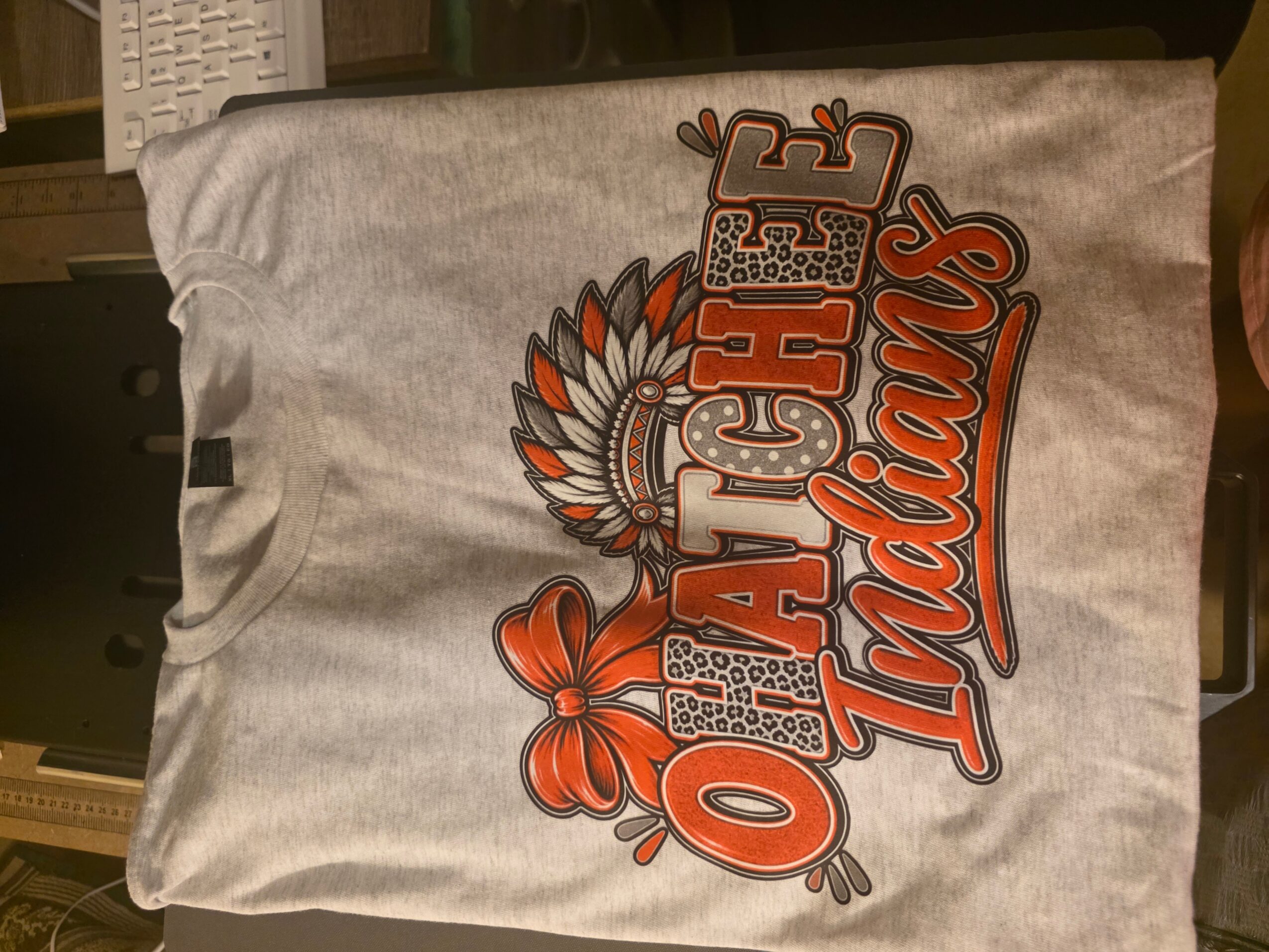 Gray fabric bag with colorful Oklahoma Thunder logo and text, featuring a Native American headdress and a butterfly, on a wooden surface.