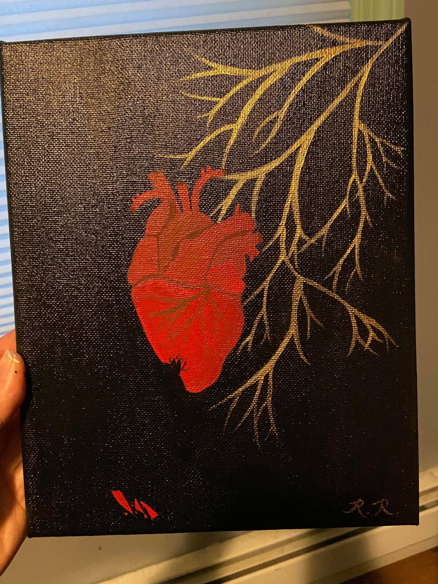 Painting of a red human heart with gold branches extending from it on a black background.
