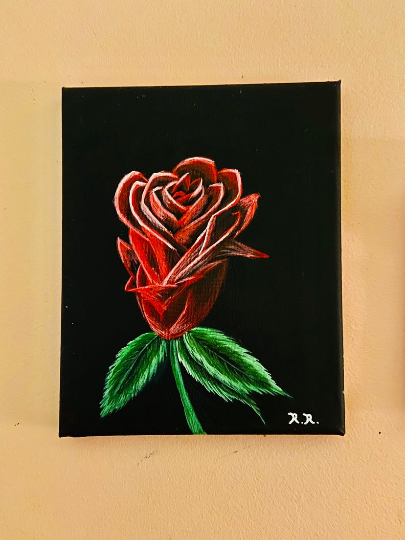 Painting of a red rose with green leaves on a black background, signed in the bottom right corner.