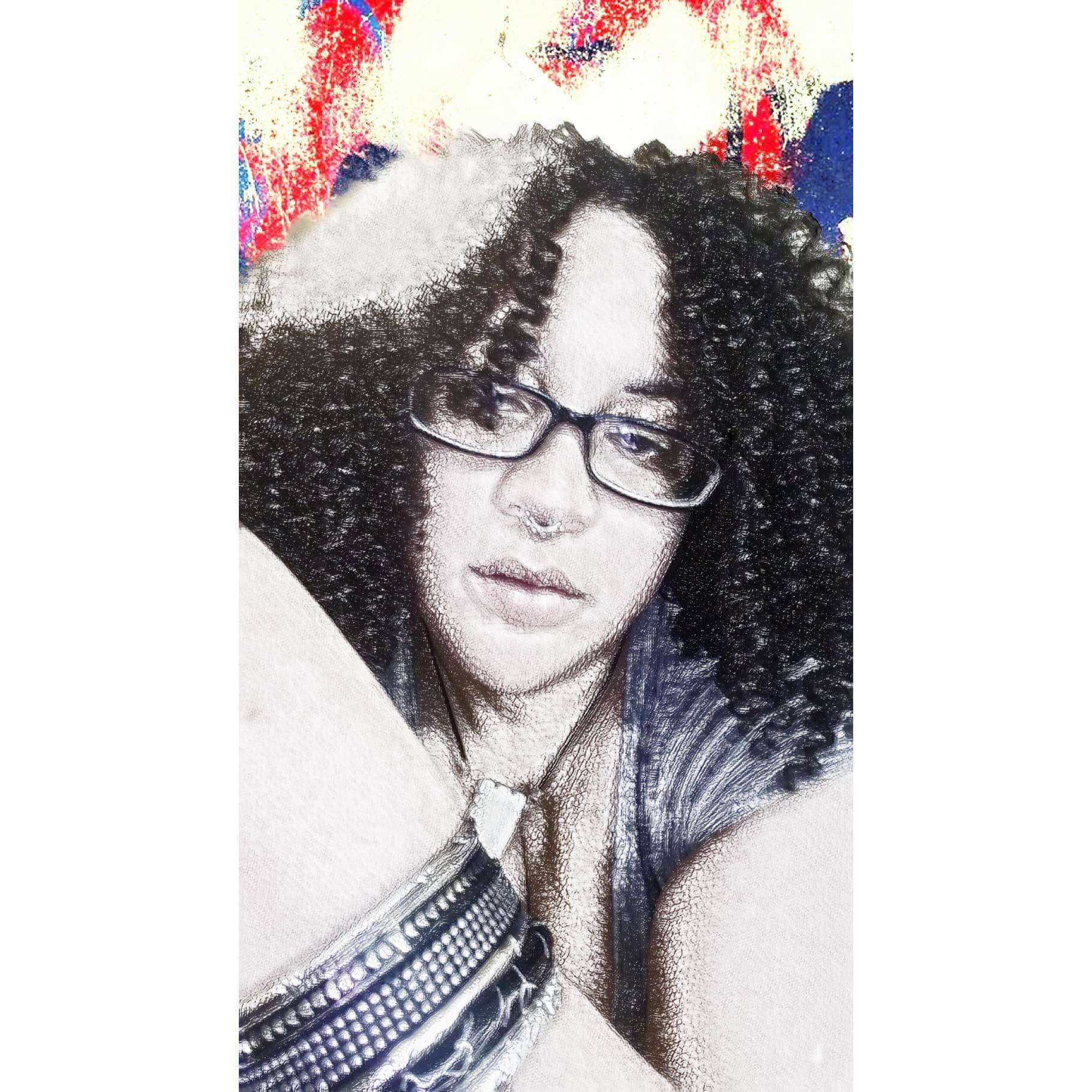 Woman with curly hair and glasses, lying down, with colorful background, looking at camera.