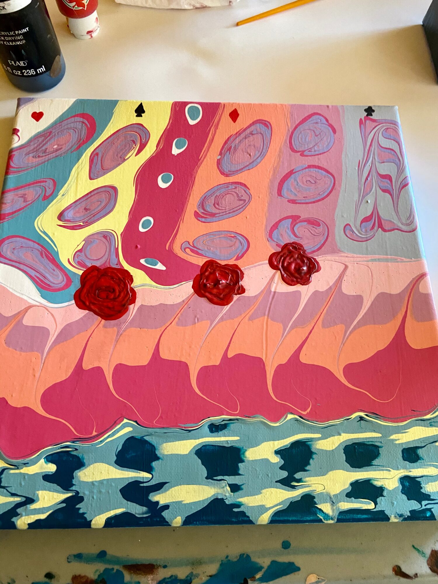 Colorful abstract painting with red roses, wavy patterns, and a mix of pastel and bold colors on a canvas.