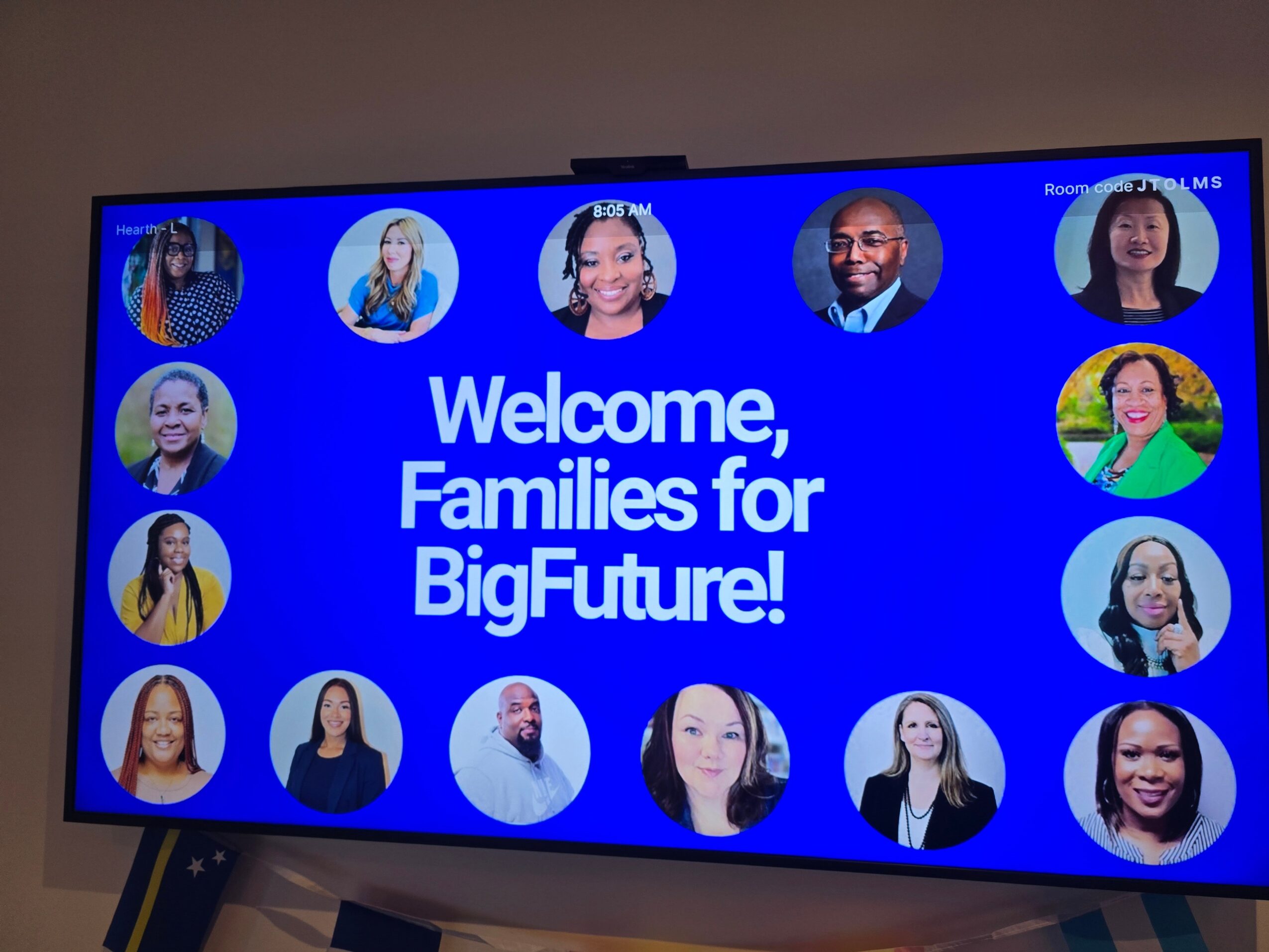 Digital screen displays a welcome message with photos of diverse people, reading 'Welcome, Families for BigFuture!'.