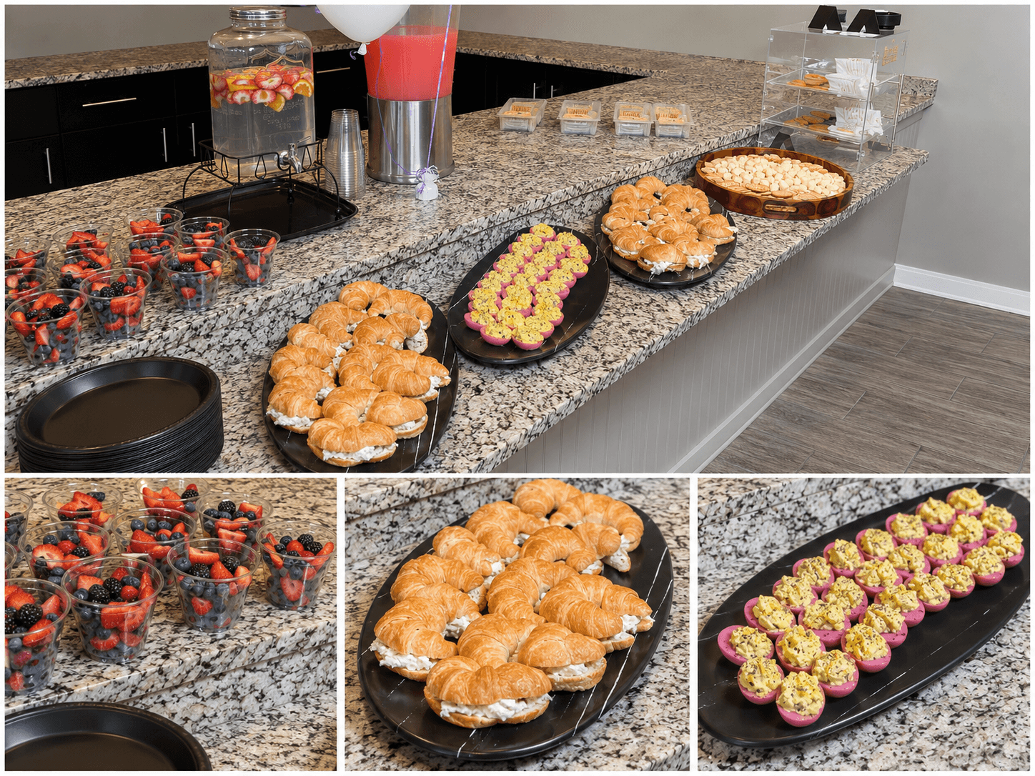 Countertop with assorted desserts and drinks, including cupcakes, cookies, and a tray of small pastries, with a granite surface and a gray wall.